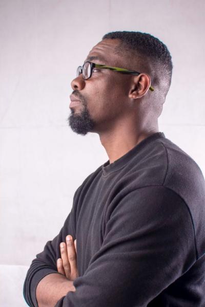 A lecturer in glasses looking ahead