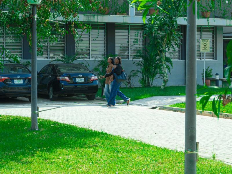 Two students walking past a faculty building